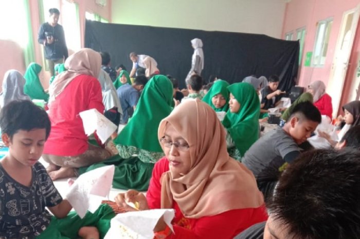 seorang siswa memotong selembar kain terbaru